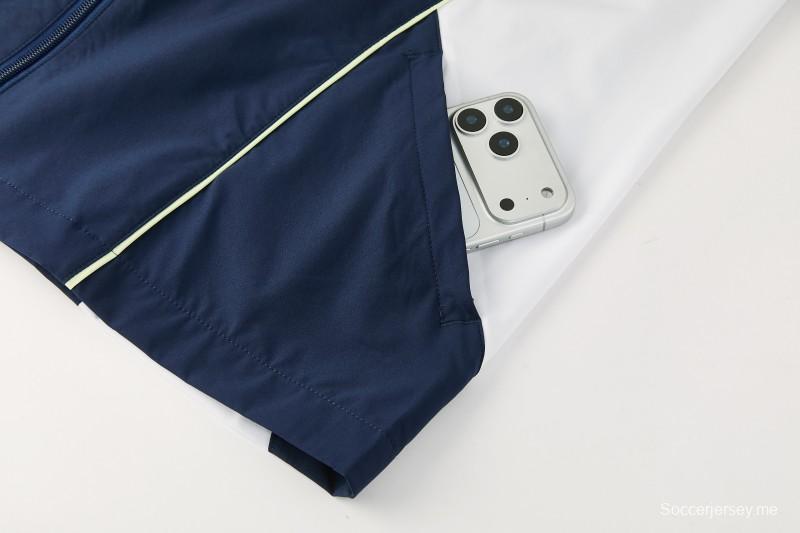 26/27 بدلة رياضية من ريال مدريد باللون الأزرق الداكن مع سترة واقية من الرياح بغطاء للرأس وسحاب كامل + بنطال طويل