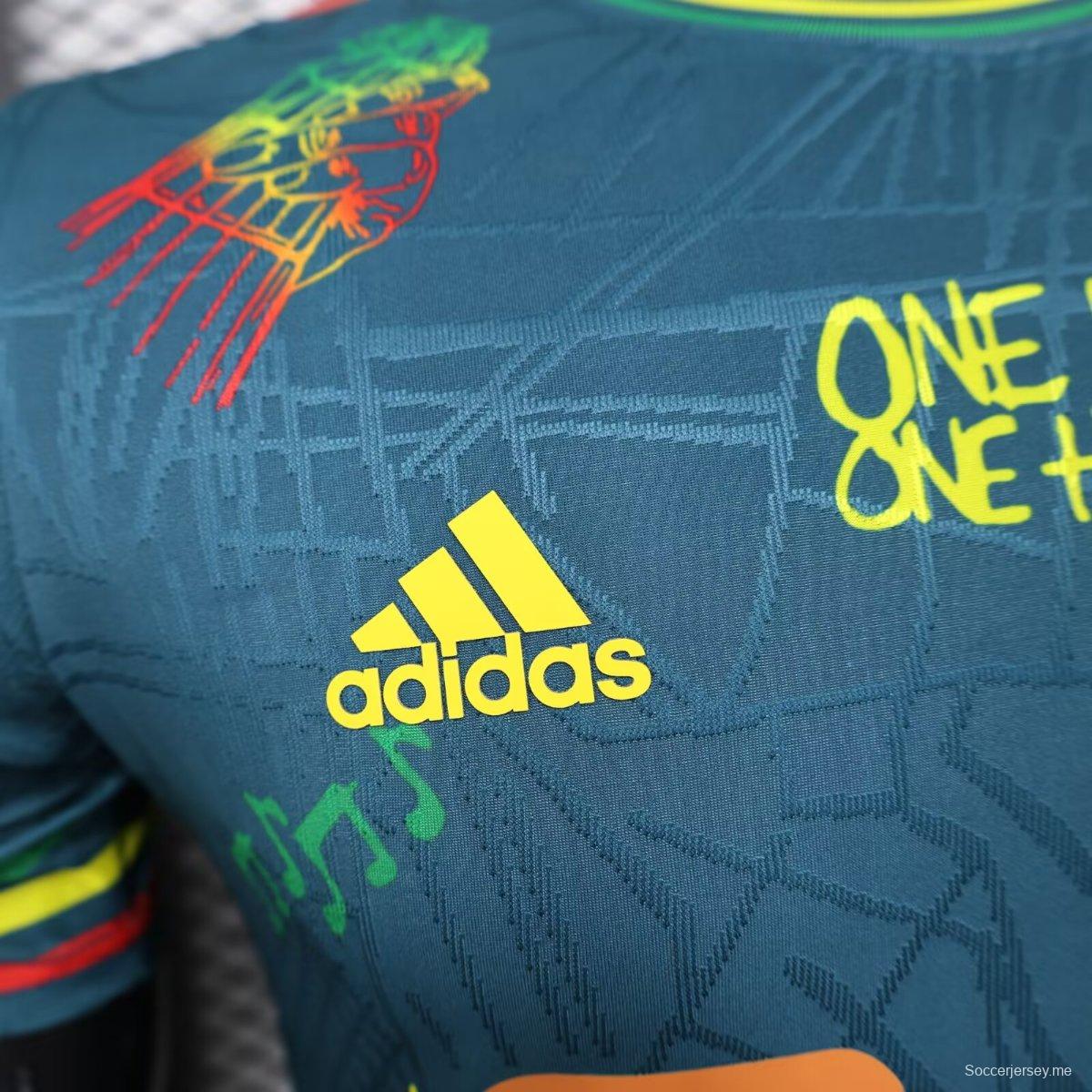 قميص أجاكس 25/26 أزرق داكن مع قميص بوب مارلي التذكاري