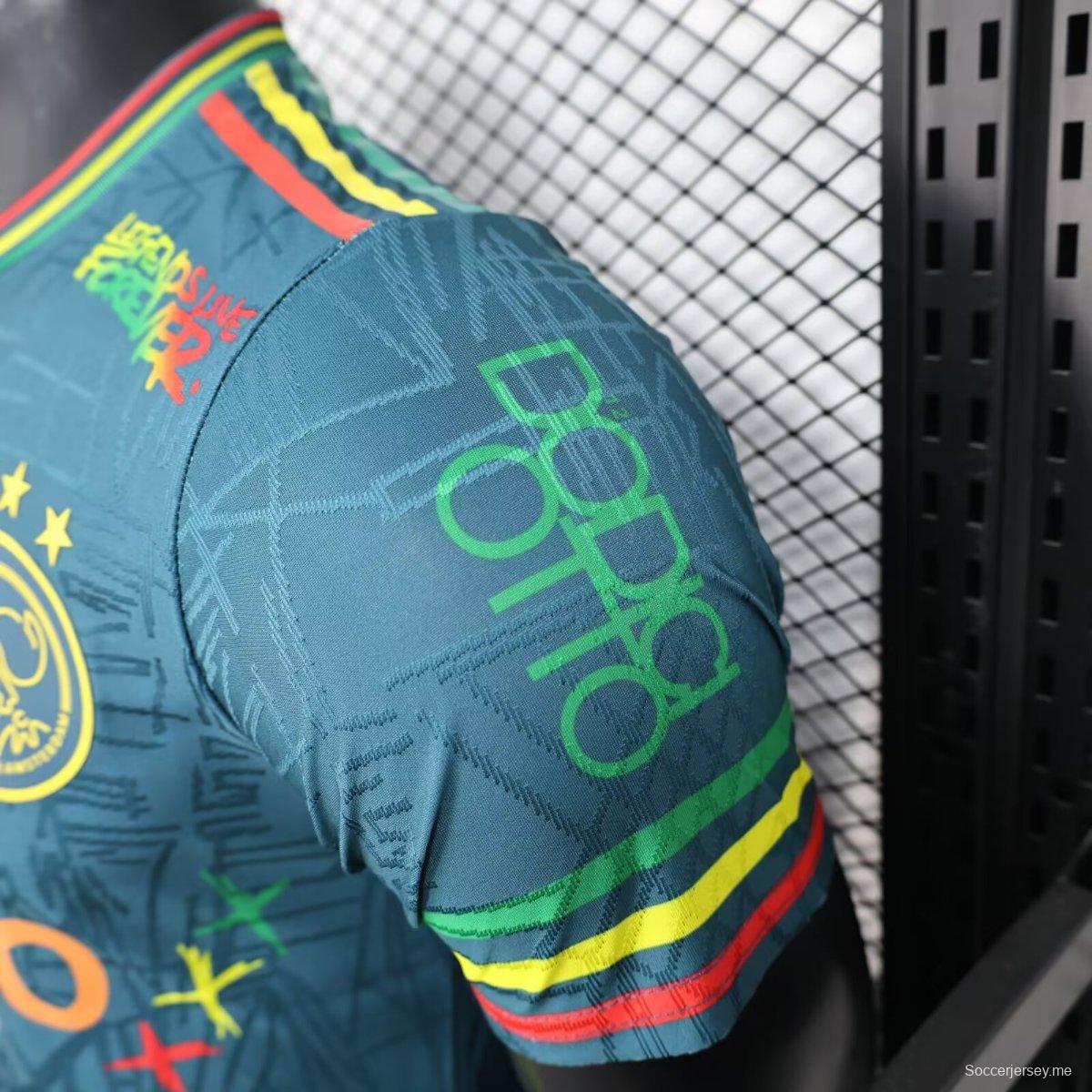 قميص أجاكس 25/26 أزرق داكن مع قميص بوب مارلي التذكاري